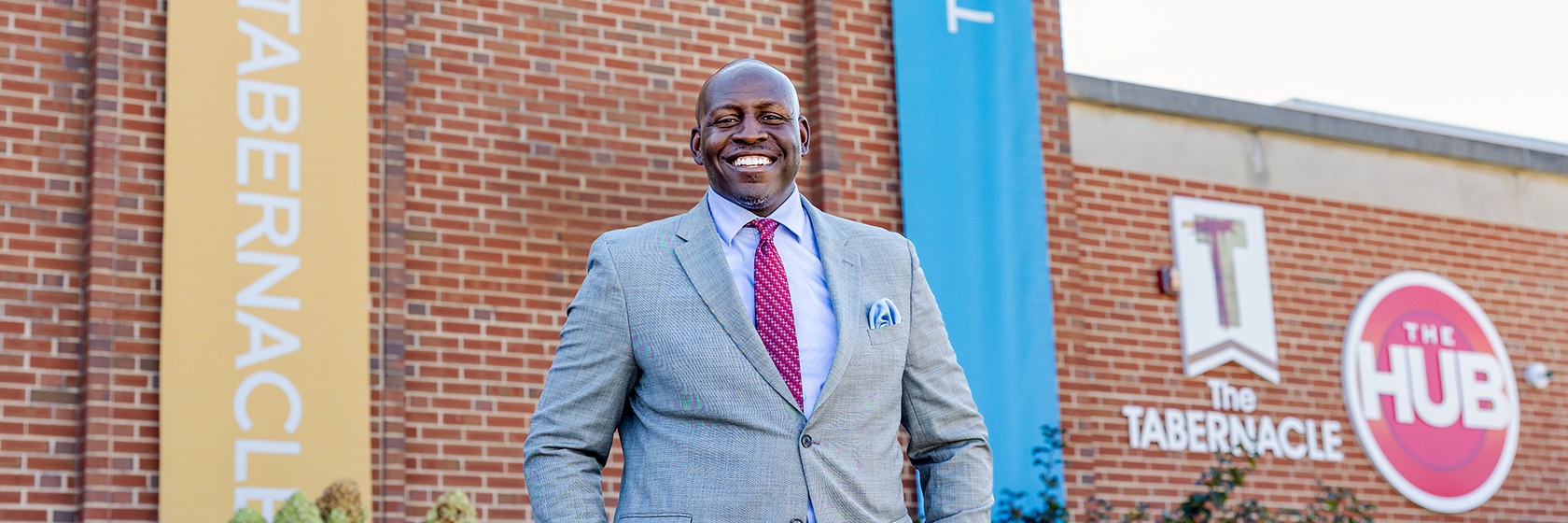 Image of a smiling gentleman in a gray suit