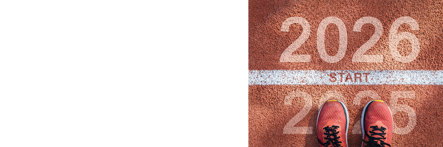 Image of a starting line on a racetrack with 2026 above it and 2025 behind it